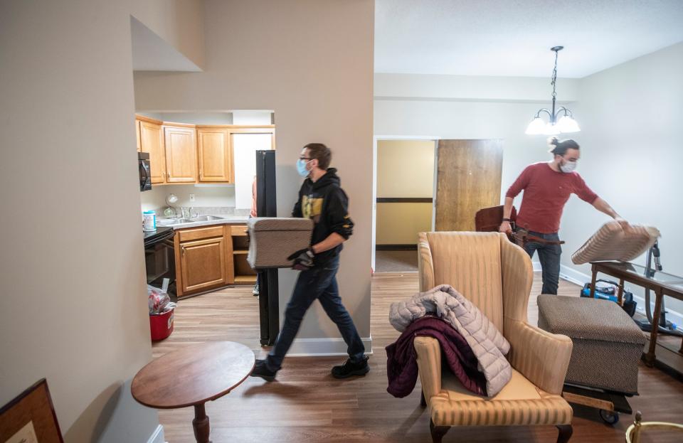 Kay Barringer's company helps the elderly move from their homes to assisted living. Andrew Miller, left, and Cody LeGrande, right, move Estrella Langub's furniture to her new apartment at the Masonic Home. Jan 14, 2022