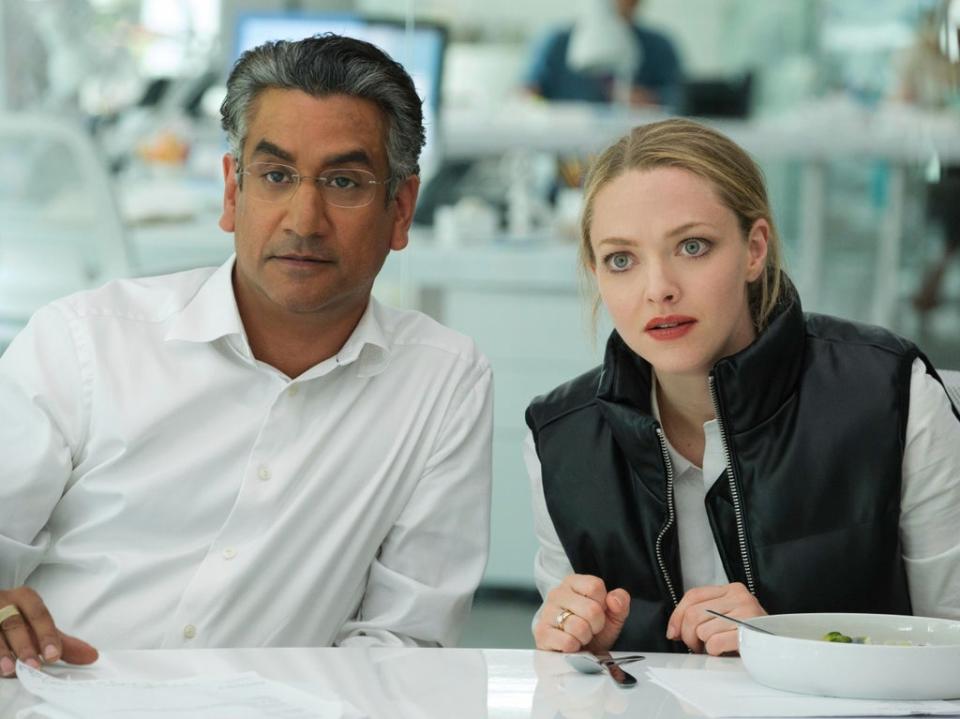 Naveen Andrews as Sunny Balwani, left, and Amanda Seyfried as Elizabeth Holmes (AP)