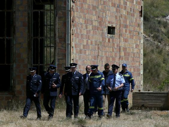 Police at a flooded mineshaft near Nicosia where two female bodies were found in April (AP)