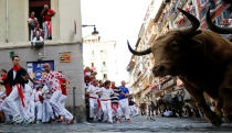 <p>Runners sprint ahead of bulls during the first running of the bulls at the San Fermin festival in Pamplona, northern Spain, July 7, 2017. (Susana Vera/Reuters) </p>