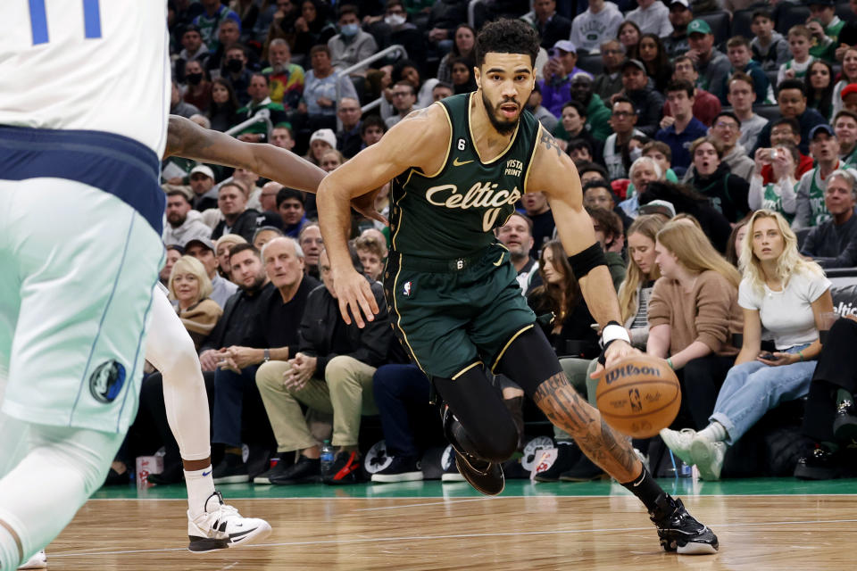 Boston Celtics forward Jayson Tatum (0) drives the basket during the first half of an NBA basketball game against the Dallas Mavericks, Wednesday, Nov. 23, 2022, in Boston. (AP Photo/Mary Schwalm)