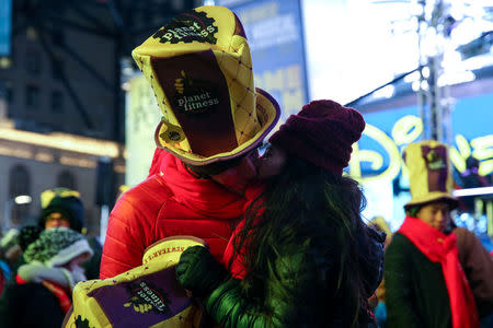 A couple kisses in Times Square ahead of the New Year's Eve celebrations in Manhattan, New York, U.S., December 31, 2017. REUTERS/Amr Alfiky