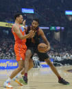Cleveland Cavaliers' Evan Mobley (4) drives against Oklahoma City Thunder's Darius Bazley (7) in the first half of an NBA basketball game, Saturday, Jan. 22, 2022, in Cleveland. (AP Photo/Tony Dejak)