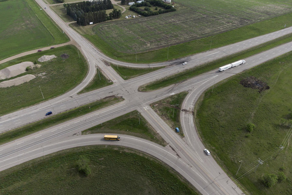 A scorched patch of ground where a bus carrying seniors to a casino ended up after colliding with a semi-trailer truck and burning on Thursday is seen on the edge of the Trans-Canada Highway near Carberry, Manitoba, Friday, June 16, 2023. Police said 15 people were killed and 10 more were sent to hospital. (Darryl Dyck/The Canadian Press via AP)