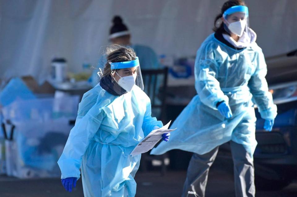 Healthcare workers prepare to collect and gather information from persons wanting a COVID-19 test at StarMed Family and Urgent Care on Tuckaseegee Road in Charlotte, NC in 2021. The independent provider is laying off workers and closing locations to battle rising costs.