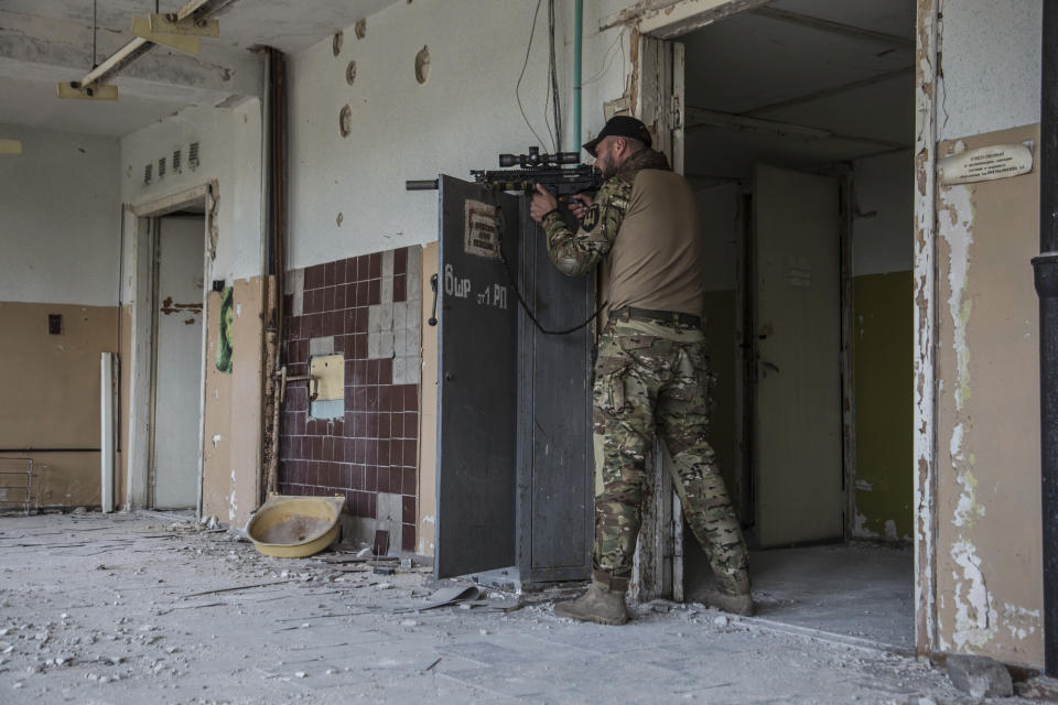 A Ukrainian soldier stands in position during heavy fighting on the front line in Severodonetsk, the Luhansk region, Ukraine, Wednesday, June 8, 2022. (AP Photo/Oleksandr Ratushniak)