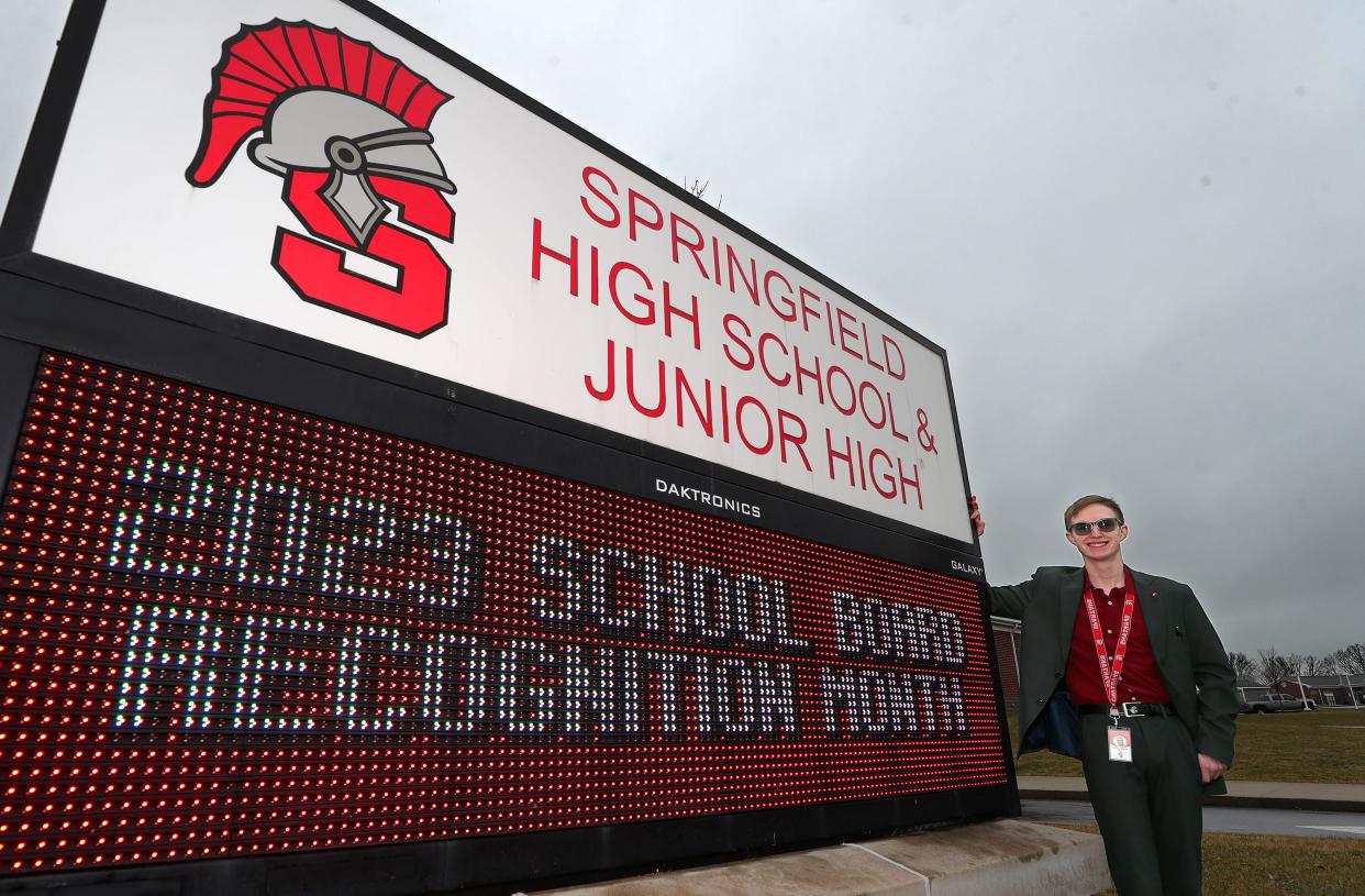 Parker Mason poses for a photo outside of Springfield High School, Thursday, Jan. 25, 2024, in Springfield Township, Ohio. In November the 19-year-old was elected to serve on his alma mater's board of education.