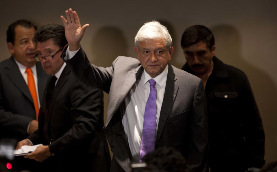 Andres Manuel Lopez Obrador, presidential candidate for the Democratic Revolution Party (PRD), waves during a news conference in Mexico City, Thursday, July 12, 2012. Lopez Obrador says he will ask an electoral court to invalidate the results of the July 1 presidential election, charging there was vote buying and campaign overspending by the winner of official vote counts. (AP Photo/Eduardo Verdugo)