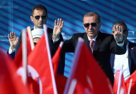 Turkey's President Tayyip Erdogan greets the crowd during the opening ceremony of newly built Yavuz Sultan Selim bridge, the third bridge over the Bosphorus linking the city's European and Asian sides, in Istanbul, Turkey, August 26, 2016. REUTERS/Murad Sezer