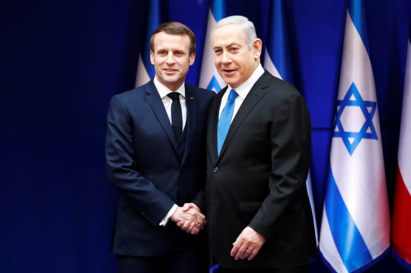 Israeli Prime Minister Benjamin Netanyahu and French President Emmanuel Macron shake hands during their meeting in Jerusalem