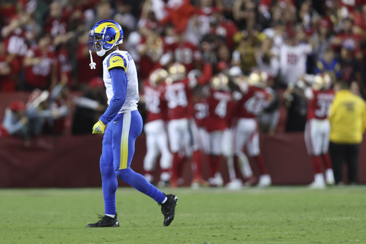 Los Angeles Rams wide receiver Allen Robinson II walks off the field as San Francisco 49ers players celebrate safety Talanoa Hufanga's touchdown off an interception. (AP Photo/Jed Jacobsohn)