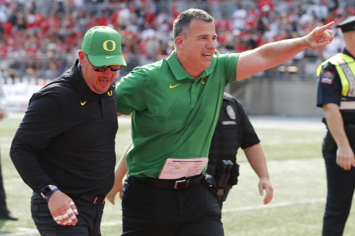 Oregon head coach Mario Cristobal, right, celebrates their 35-28 win over Ohio State after an NCAA college football game Saturday, Sept. 11, 2021, in Columbus, Ohio. (AP Photo/Jay LaPrete)