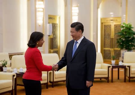 U.S. National Security Advisor Susan Rice (L), shakes hands with Chinese President Xi Jinping during a meeting at the Great Hall of the People, in Beijing September 9, 2014. REUTERS/Andy Wong/Pool