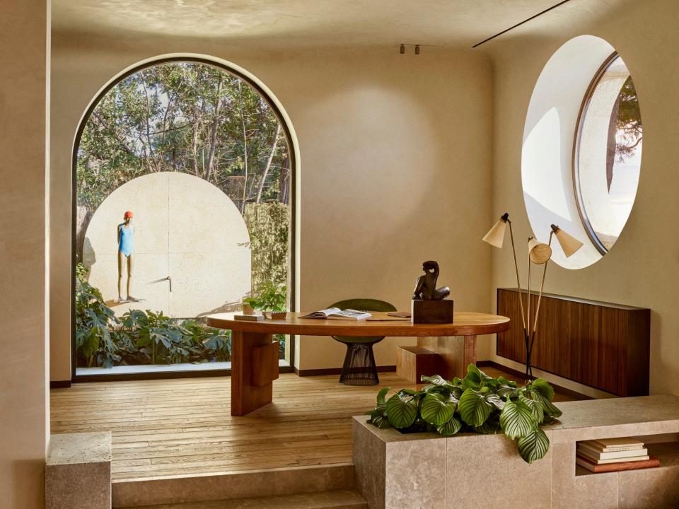 In the office, a sculpture by Michèle Raymond is seen near a free-form desk inspired by Charlotte Perriand. The Platner lounge chair is from Knoll while the outdoor fountain sculpture, titled,La Baigneuse, is by Sylvie du Plessis.