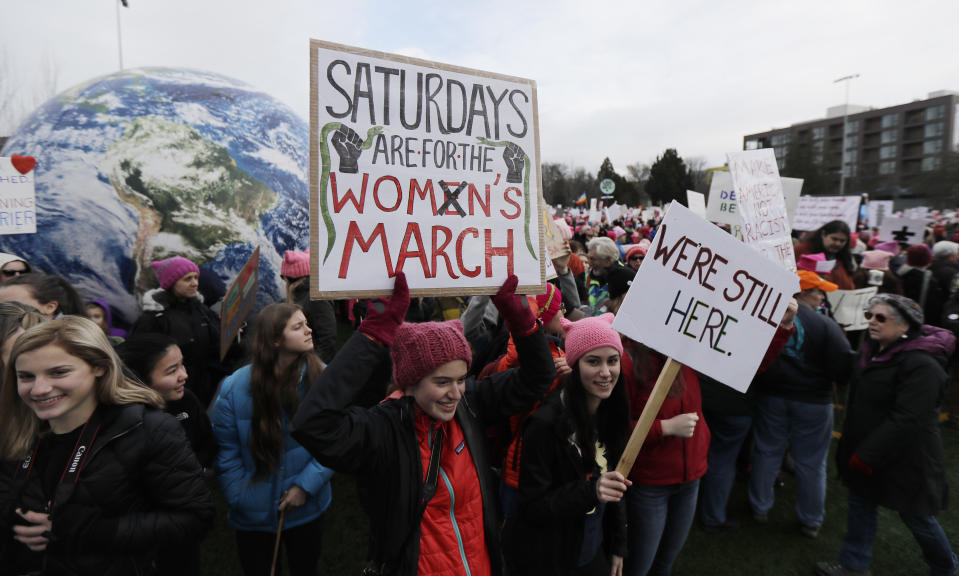 <p>A woman holds as sign as she takes part in a Women’s March in Seattle, Saturday, Jan. 20, 2018. (Photo: Ted S. Warren/AP) </p>