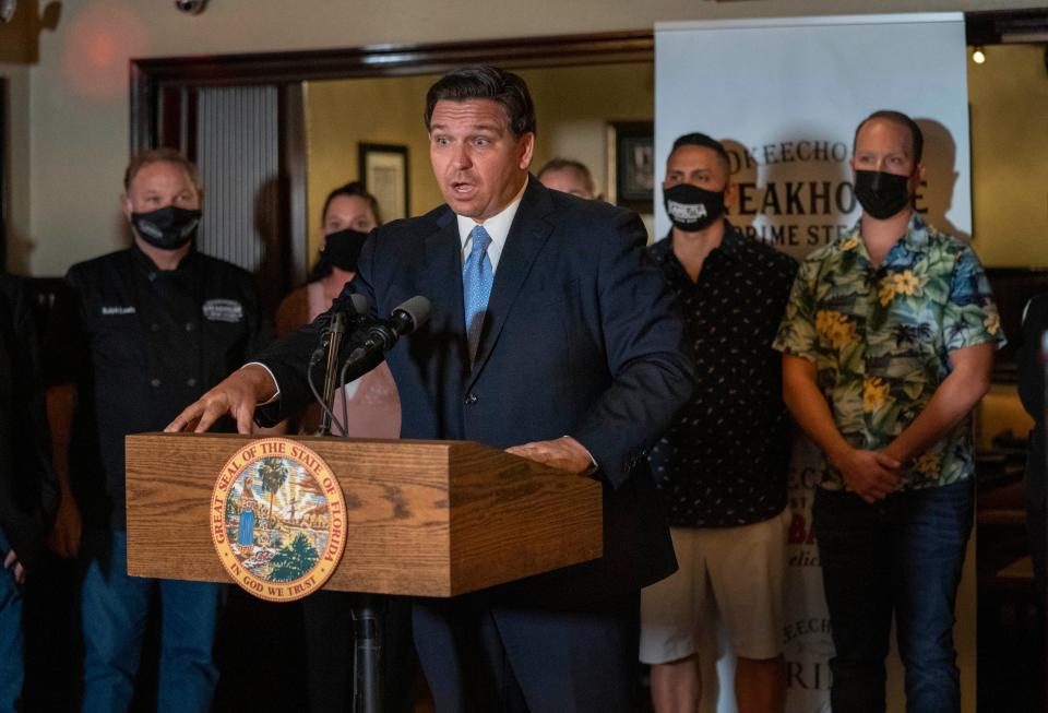 Florida Governor Ron DeSantis speaks during a press conference at the Okeechobee Steakhouse on December 15, 2020 in West  Palm Beach, Florida. DeSantis talked about the importance of keeping restaurants open during the pandemic  to help employees earn a living. (GREG LOVETT/THE PALM BEACH POST)