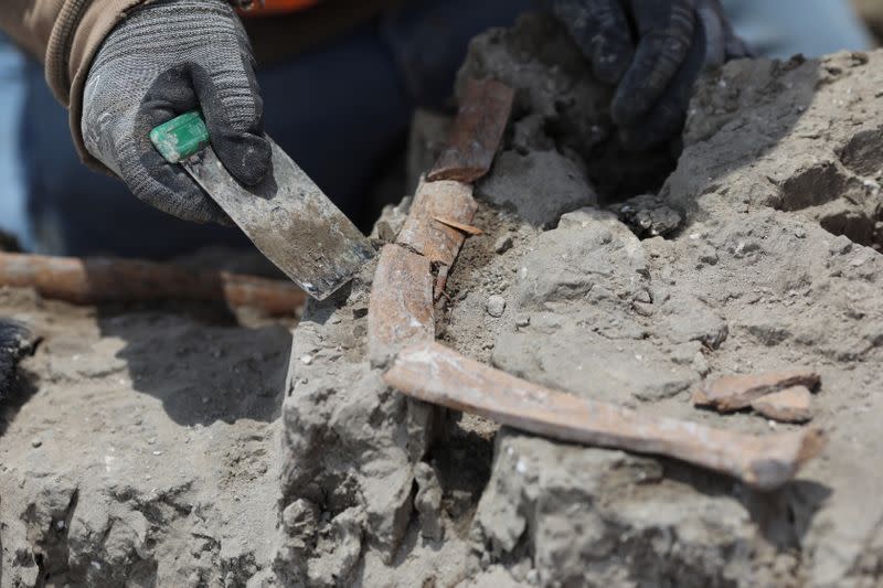 Archaeologists from the National Institute of Anthropology and History (INAH) work at a site where they are unearthing remains of mammoths, in Zumpango