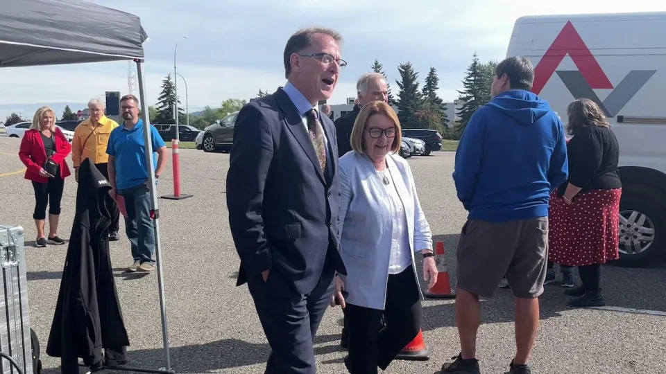 Health minister Adrian Dix and MLA Shirley Bond walk together at an event in Prince George, B.C. on Sept. 13, 2024.