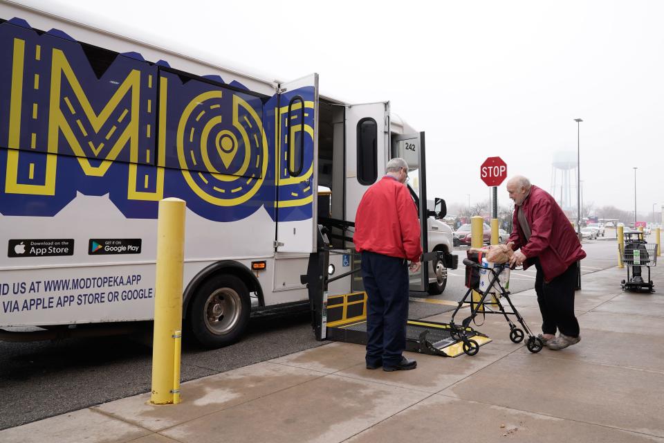 Topeka resident John Lester is assisted onto a ramp for his ride on a Topeka Transit MOD bus Wednesday after he finished grocery shopping at Dillons in southeast Topeka.