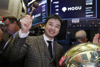 Mogu Inc. co-founder, Chairman and CEO Shark Chen rings a ceremonial bell as his company's IPO begins trading on the floor of the New York Stock Exchange, Thursday, Dec. 6, 2018. (AP Photo/Richard Drew)