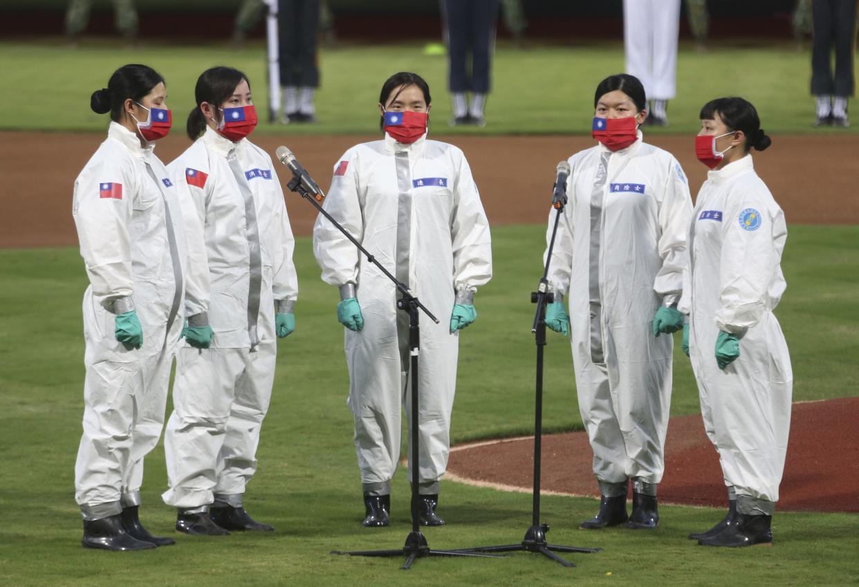A group of people sing the national song before the baseball game at Xinzhuang Baseball Stadium in New Taipei City, Taiwan on May 8, 2020.