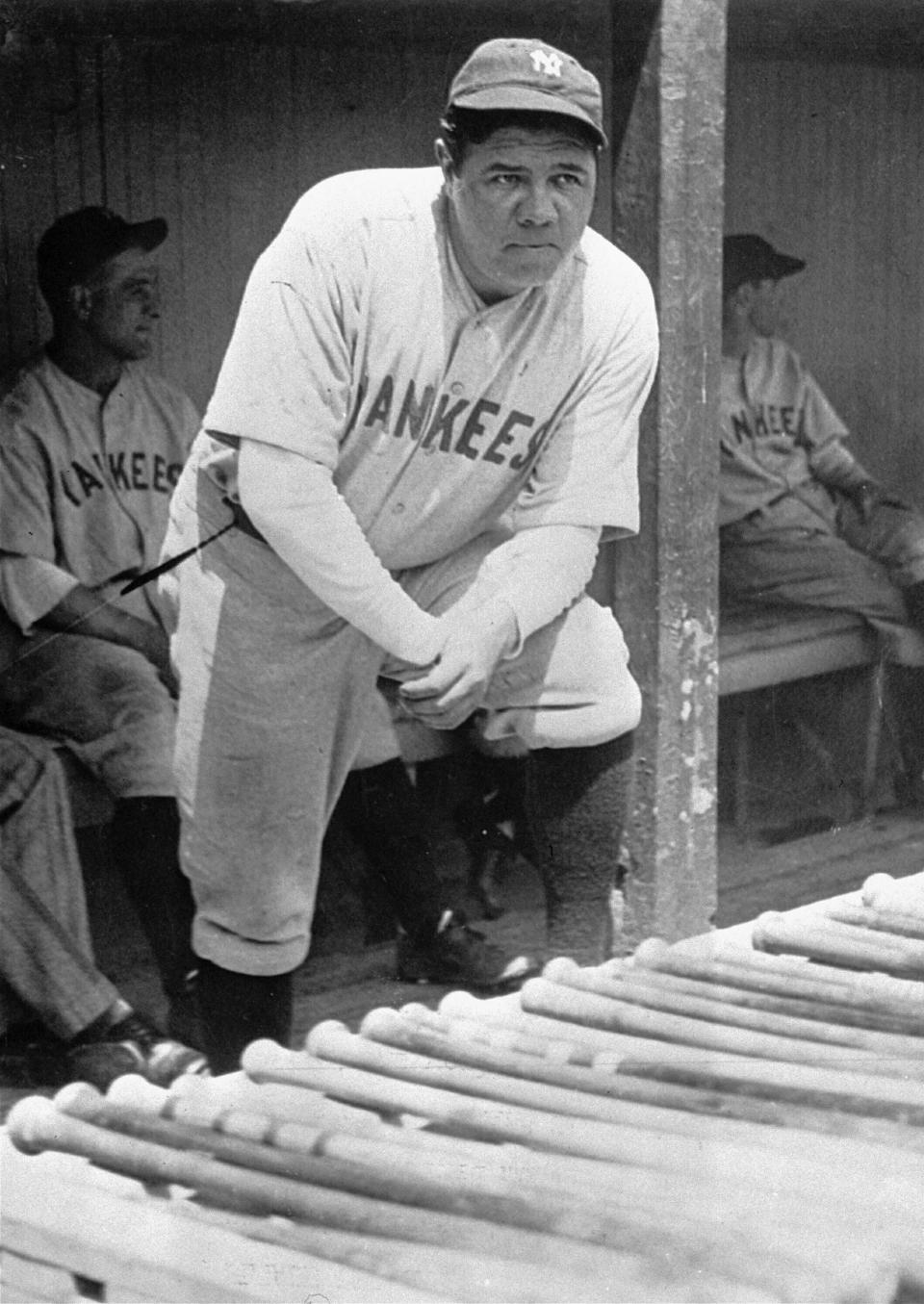 In this July 1929 file photo, New York Yankees' Babe Ruth, who was injured, stands in the dugout during the baseball team's game at Cleveland.