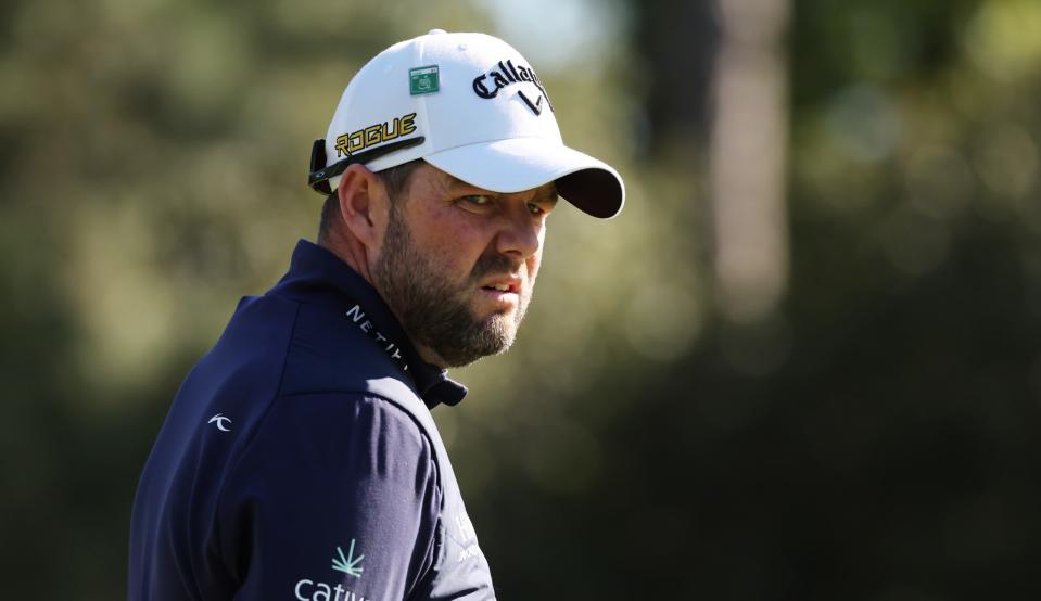 Leishman stares on with a hat on