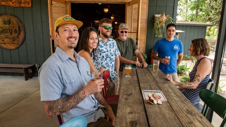 Gary Yetter (left) of Gary's Brewery and Biergarten has a beer with family and friends Sunday, April 2, 2023.