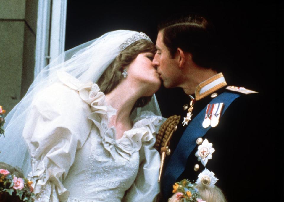 The Prince and Princess of Wales kiss on the balcony of Buckingham Palace after their wedding (PA) (PA Archive)