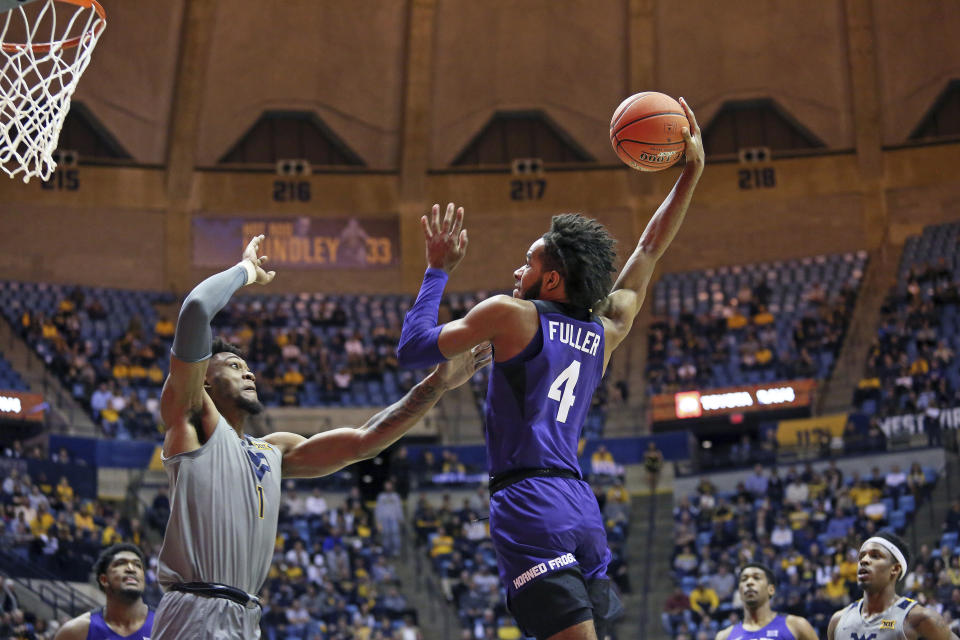 TCU guard PJ Fuller (4) shoots as West Virginia forward Derek Culver (1) defends during the first half of an NCAA college basketball game Tuesday, Jan. 14, 2020, in Morgantown, W.Va. (AP Photo/Kathleen Batten)