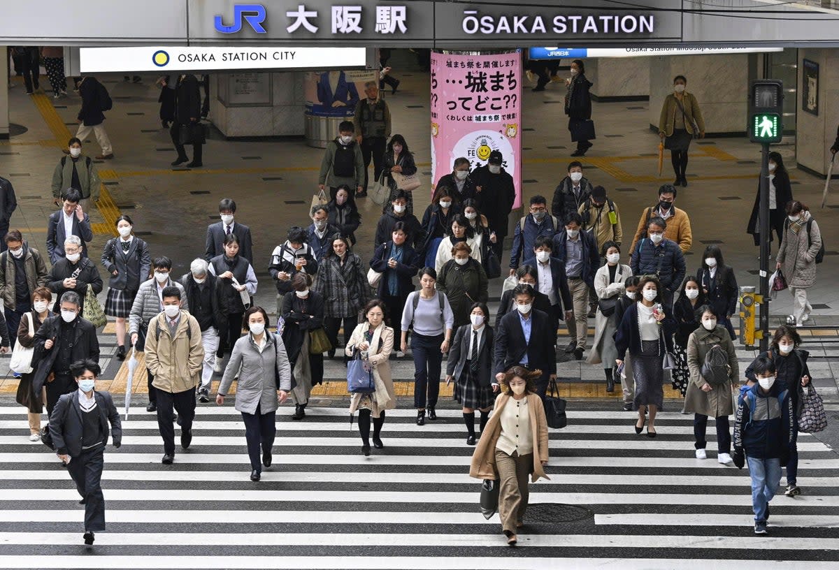 File photo: People walk across an intersection in Osaka, western Japan, Monday, 13 March 2023  (Kyodo News)