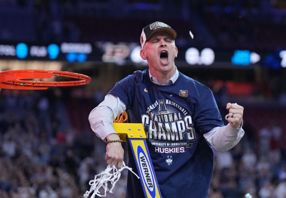 Connecticut coach Dan Hurley celebrates after cutting down the net Monday after his Huskies won their second straight national title.