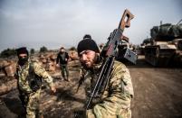 <p>Turkish troops advance near the Syria border at Hassa, Hatay province, on Jan. 22, 2018, as part of the operation “Olive Branch,” launched two days ago. (Photo: Bulent Kilic/AFP/Getty Images) </p>