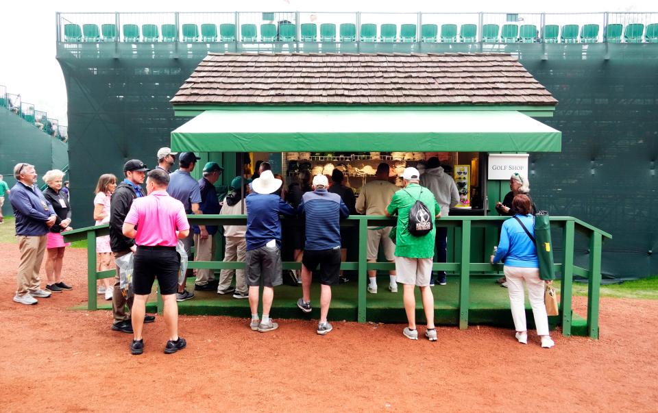 Apr 4, 2023; Augusta, Georgia, USA; Patrons shop for merchandise behind the grandstand at no. 14 tee during a practice round for The Masters golf tournament at Augusta National Golf Club. Mandatory Credit: Rob Schumacher-USA TODAY Network