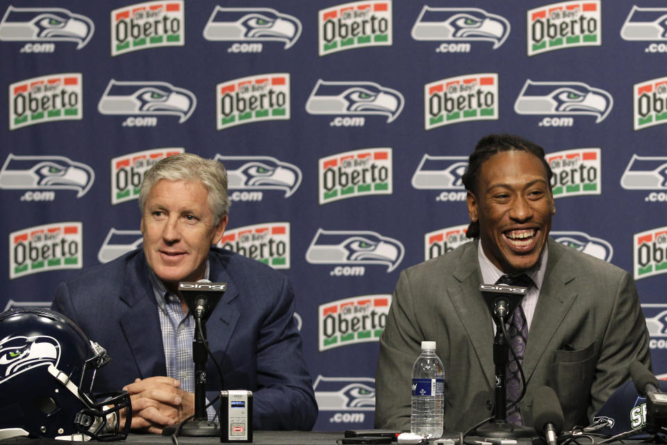 FILE - In this April 28, 2012, file photo, Seattle Seahawks top NFL football draft pick, Bruce Irvin and Seahawks head football coach Pete Carroll, left, take questions from reporters after Irvin was introduced in Renton, Wash. Irvin is thrilled to be back where his NFL journey started. Irvin jumped at the chance to return to Seattle this offseason, but his reunion with the Seahawks comes with the expectation he can help a lackluster pass rush. (AP Photo/Ted S. Warren, File)