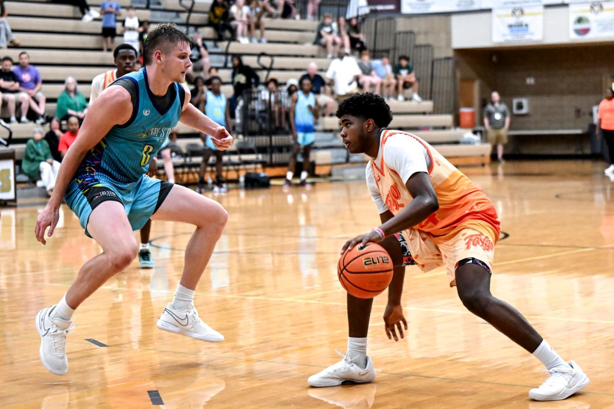 Team Faygo and Michigan State's Jase Richardson, right, moves the ball as his MSU teammate Jaxson Kohler and Team Tri-Star Trust defends in the game on Tuesday, July 9, 2024, during the Moneyball Pro-Am at Holt High School.