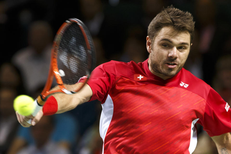 Stanislas Wawrinka, of Switzerland, returns a ball to Mikhail Kukushkin, of Kazakhstan, during the third single match of the tennis Davis Cup World Group quarterfinal between Switzerland and Kazakhstan, in Geneva, Switzerland, Sunday, April 6, 2014. (AP Photo/Keystone,Salvatore Di Nolfi)