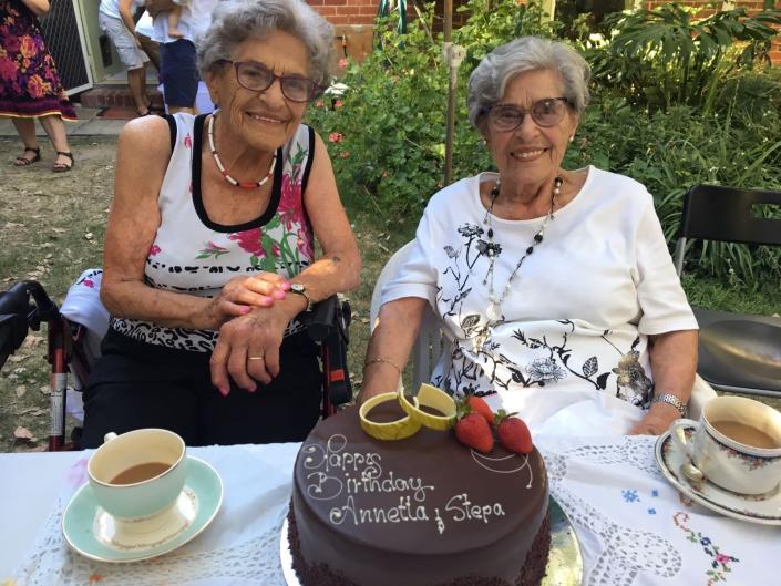 Twin concentration survivors Stepha Heller and Annetta Ablew with their birthday cake in 2019.