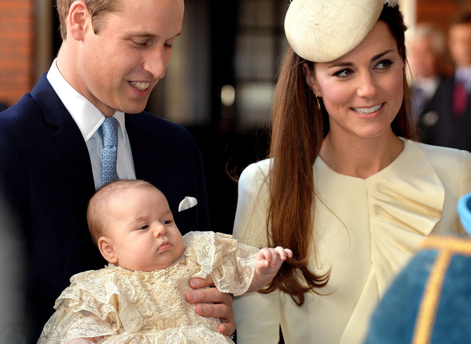 Britain's Prince William, Duke of Cambridge and his wife Catherine, Duchess of Cambridge, arrive with their son Prince George of Cambridge at Chapel Royal in St James's Palace in central London on October 23, 2013