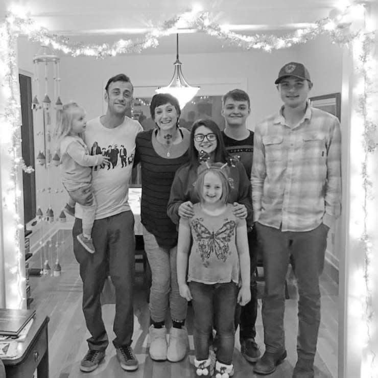 Austin Turner, at the far right, poses with his family for a photo in 2018. In the back row, from left to right are: his sister Beatrix Turner, his father, Josh Turner, his stepmother, Meagan Turner, his sister Taylor Felts and his brother-in-law Zachary Felts. His sister Avalyn Turner is standing at the bottom center.
