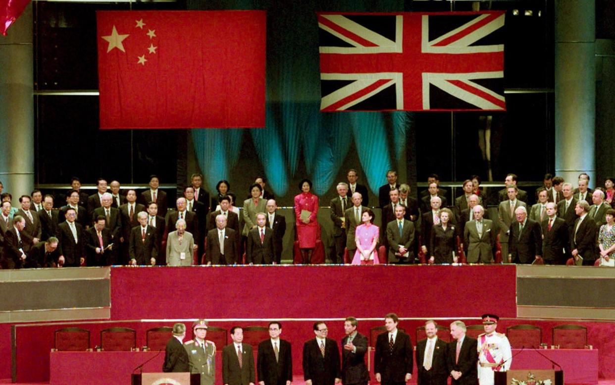 Leaders of China and Britain, including Chris Patten, stand to attention at the handover ceremony in 1997 - Jason Reed REUTERS