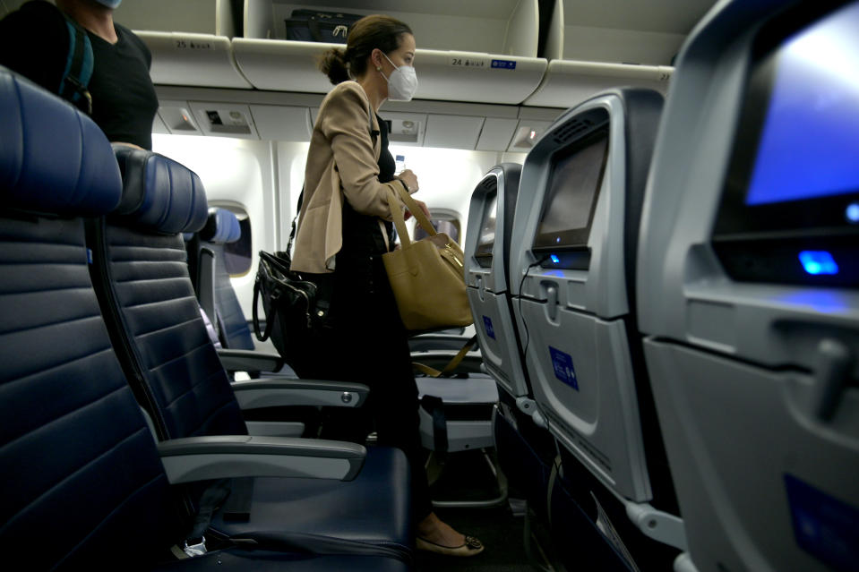 IN FLIGHT - OCTOBER 22: A masked passenger is seen exiting the aircraft following a flight from Newark, New Jersey to Los Angeles, California on October 22, 2020.  The global pandemic has had a devastating impact on aviation and airlines don't believe they will see much improvement until a reliable COVID-19 vaccine is developed and distributed. (Photo by Michael Loccisano/Getty Images)