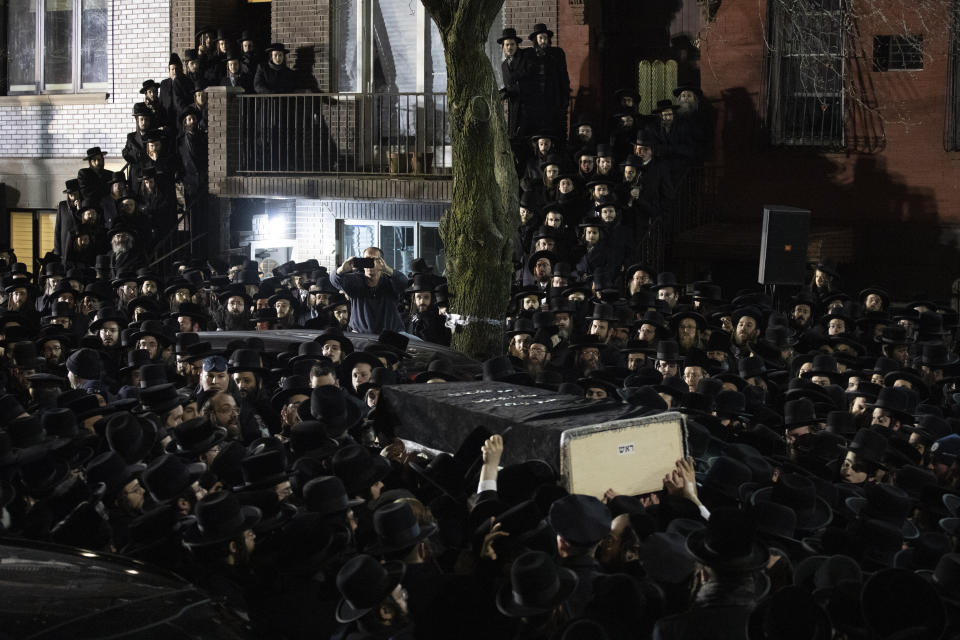 Orthodox Jewish men carry Moshe Deutsch's casket outside a Brooklyn synagogue following his funeral, Wednesday, Dec. 11, 2019 in New York. (AP Photo/Mark Lennihan) (Photo: ASSOCIATED PRESS)