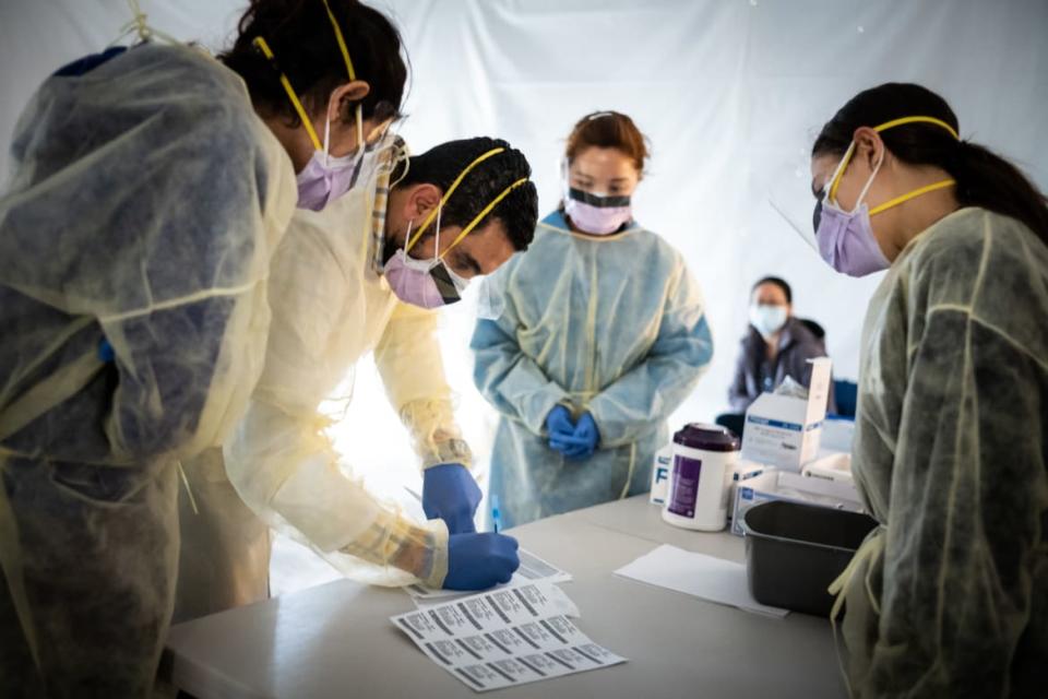 <div class="inline-image__caption"><p>Doctors test hospital staff with flu-like symptoms for coronavirus in tents outside St. Barnabas hospital in the Bronx.</p></div> <div class="inline-image__credit">Misha Friedman/Getty</div>