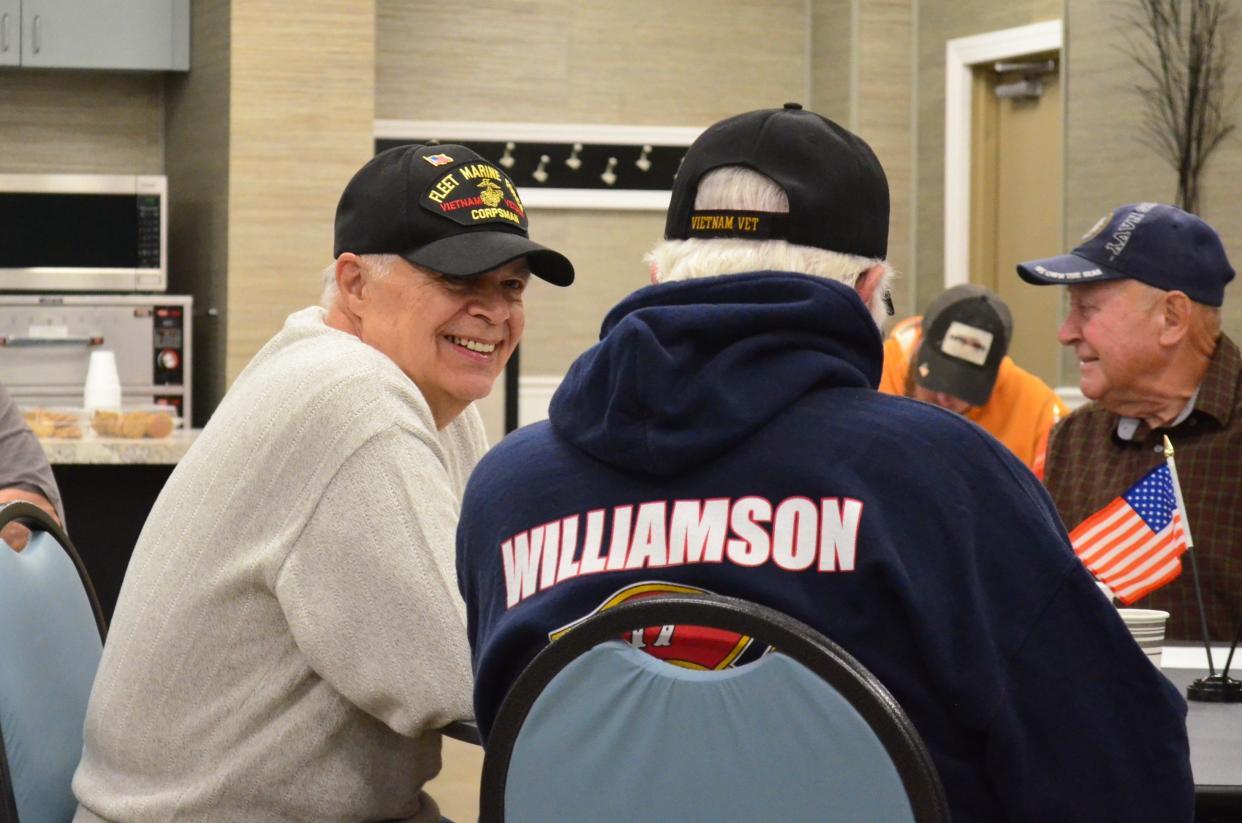 Navy corpsman Stan Kozich talks with Marine Corps veteran Richard McMahon at a Marine Corps League meeting in Fairview, Tenn., on March 23, 2022.