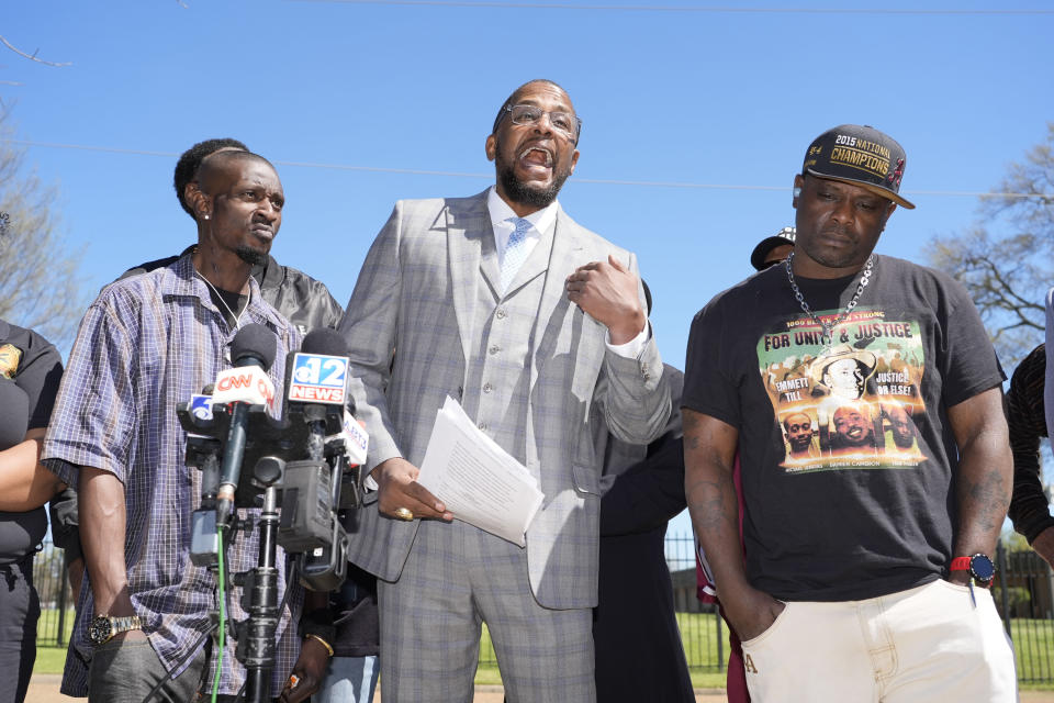 Michael Corey Jenkins, left, and Eddie Terrell Parker, right, stand with lead attorney Malik Shabazz, as he calls on a federal judge, Monday, March 18, 2024, to impose the harshest possible penalties against six former Mississippi Rankin County law enforcement officers who committed numerous acts of racially motivated, violent torture on them in 2023. They spoke at a news conference in Jackson, Miss. The six former law officers pleaded guilty to a number of charges for torturing them and they will be sentenced in federal court on Tuesday. (AP Photo/Rogelio V. Solis)