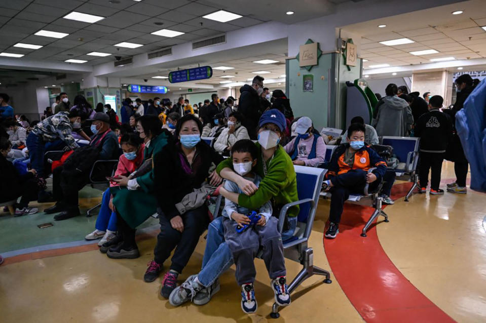 Children and their parents wait at an outpatient area at a children hospital in Beijing on November 23, 2023. 