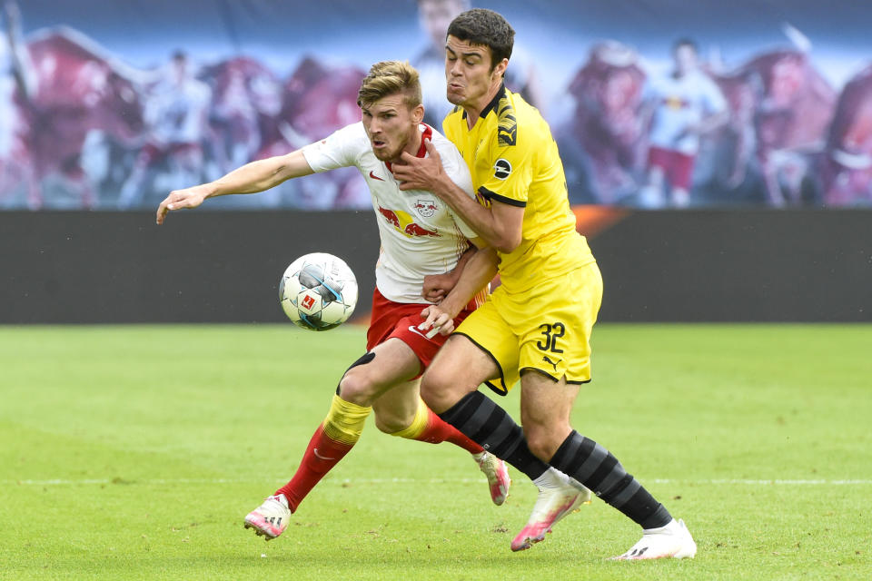 Leipzig's Timo Werner, left, and Dortmund's Giovanni Reyna fight for the ball during the German Bundesliga soccer match between RB Leipzig and Borussia Dortmund in Leipzig, Germany, Saturday, June 20, 2020. (AP Photo/Jens Meyer, Pool)