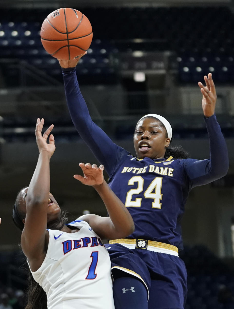 Notre Dame's Arike Ogunbowale, right, goes to the basket against DePaul's Ashton Millender during the first half of an NCAA college basketball game Saturday, Nov. 17, 2018, in Chicago. (AP Photo/Jim Young)