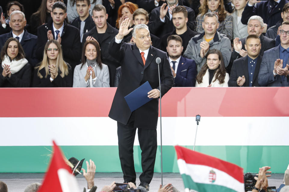 Hungarian Prime Minister Viktor Orban waves to supporters during celebration the 65th anniversary of the 1956 Hungarian revolution, in Budapest, Hungary, Saturday, Oct. 23, 2021. Thousands of supporters of Prime Minister Viktor Orban, who is expected to deliver a speech marking the 65th anniversary of the 1956 Hungarian revolution, march in Budapest, Hungary to demonstrate loyalty to his right-wing government. (AP Photo/Laszlo Balogh)